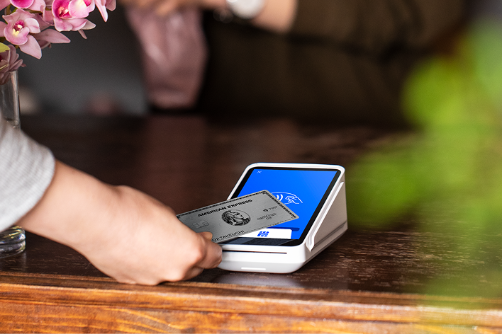 Square Terminal product image: a card held over the screen of the white payment terminal.