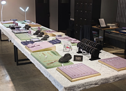 Necklaces and earrings displayed for sale on tables